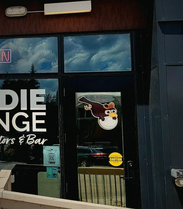The Birdie Lounge front door on Zerex Street, bird decal on the glass.